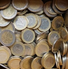 Pile of euro coins. One euro, two euro coins. Coins background. Concept of money and cash. Europe currencies. Close-up of cash. Money background