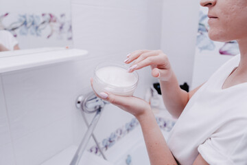 Girl using moisturizer. Cream hand apply face cosmetic concept