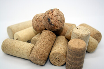 Corks from wine bottles on a white background.
