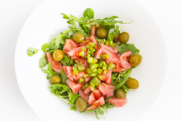 Arugula salad with tomato olives and pickles