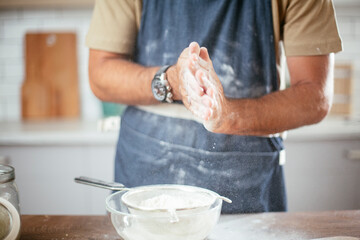 Close up of man baking in the kitchen. Man making fresh pasta.
