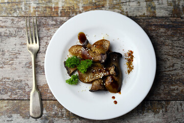 Soft focus. Eringi mushrooms on a plate with spices. Cooked eringi mushrooms.