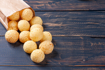 Delicious Brazilian cheese bread coming out of a paper bag. Also known in Latin America as Chipa, Pan de Bono and Pan de Yuca. Copy space