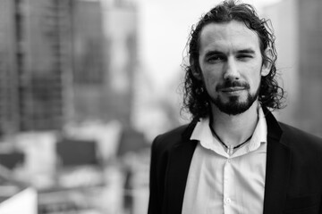 Handsome businessman against view of the city in Bangkok, Thailand