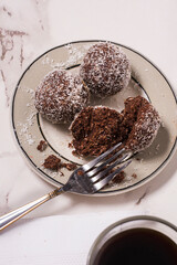 Oats bonbons on a plate and a fork