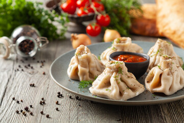 Traditional Georgian dumplings with meat. Khinkali. Served on a plate with traditional Georgian bread.