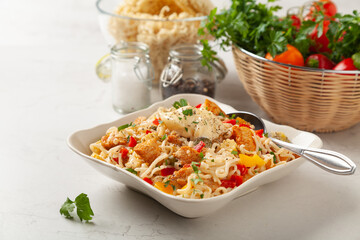 Salad with Chinese noodles and chicken, pepper, and cucumber.