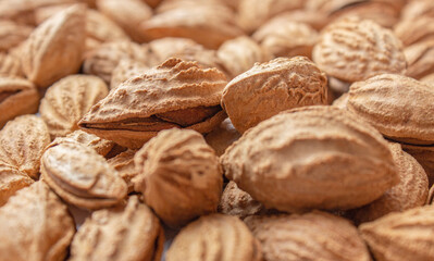 A bunch of almonds close-up. Salted fresh nuts in the shell. The texture of the almonds.