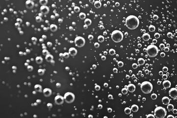 Black and white. Bubbles from soda water or champagne, beer or other liquid with air, oxygen or carbon dioxide bubbles.