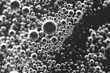Black and white. Bubbles from soda water or champagne, beer or other liquid with air, oxygen or carbon dioxide bubbles.