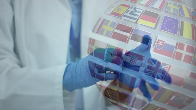 Animation of a globe of world flags and doctor putting on gloves