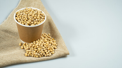 Soybeans in a paper bowl isolated on a white background, side view with copy space for text. element of food healthy nutrients and herb vegetable ingredient concept