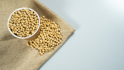 Soybeans in a paper bowl isolated on a white background, side view with copy space for text. element of food healthy nutrients and herb vegetable ingredient concept