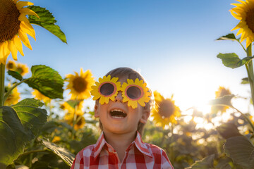 Happy child playing outdoor in spring field