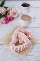 Two pink hearts made from meringues and coffee