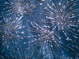 Material from the festive dress of blue color with glitters background, texture