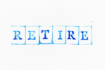 Blue color ink rubber stamp in word retire on white paper background