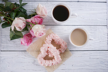 Two pink hearts made from meringues and coffee