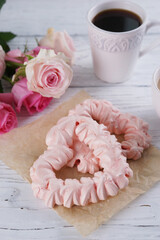 Two pink hearts made from meringues and coffee