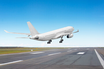 Aircraft landing on the runway, flight before touching the asphalt, rear view to the runway end.