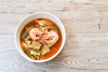 fried egg stuffed climbing wattle and shrimp with vegetable in spicy sour soup on bowl