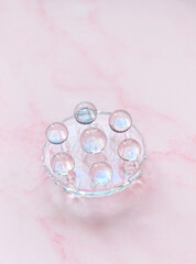 Clear quartz balls on glass grid, pink abstract background. Magic Crystal Ritual. Witchcraft,...