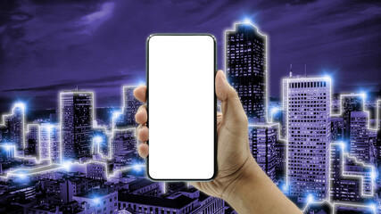Concept of future technology 6G, Network digital hologram and internet of things on city background. Hand holding, New version of black slim smartphone similar to iphone 13 with blank white screen.
