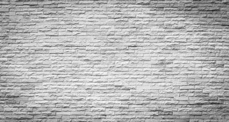 Gray sandstone brick wall textured background.