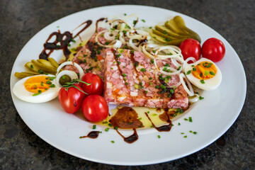 homemade brawn with eggs, cherry tomatoes, onions and pickles in olive oil and balsamic vinegar