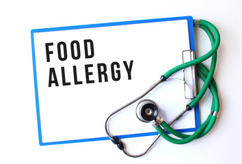 FOOD ALLERGY text on a medical folder and stethoscope on white background