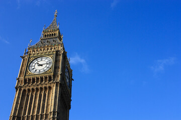 Fototapeta na wymiar Close-up of the top part of Big Ben in London, against a clear blue sky