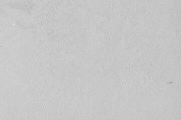 Cardboard gray texture close-up. Light old paper background. Grunge concrete wall. Vintage blank wallpaper.