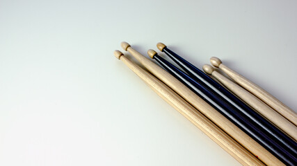 Drumsticks of black and light color on a light table