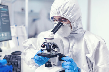 Woman scientist in laboratoruy searching for coronavirus cure dressed in ppe suit. Chemist...