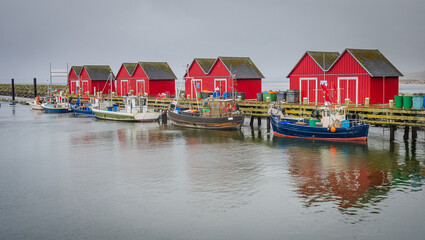 Fototapeta na wymiar Boats tied to pier in a cloudy day