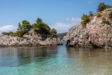 Big Rock in the blue waters of Stafilos Beach, Skopelos, Skopelos Island, Greece.