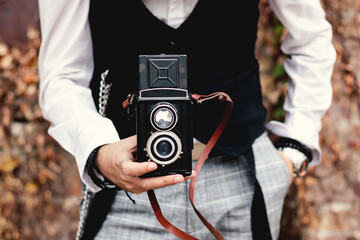 Close-up of photographer using vintage medium format photo camera.