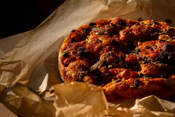 Tasty-looking typical Italian flatbread called 'Focaccia' with tomatoes and anchovies.