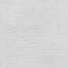Cardboard gray texture close-up. Light old paper background. Grunge concrete wall. Vintage blank wallpaper.