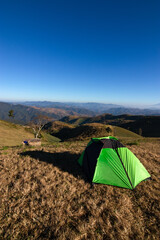 Green tent in the mountains.