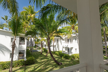 White villas exterior in tropical garden at sunny day