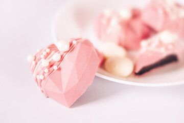 Pink heart-shaped cake on a plate. Gift for Valentine's Day and Women's Day