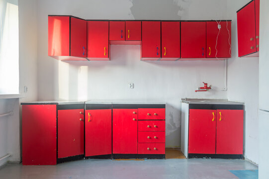 Old kitchen with red kitchen cabinets.