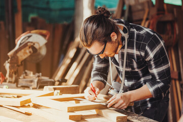 Confident wood worker expert. Young man working at factory. Skilled carpenter