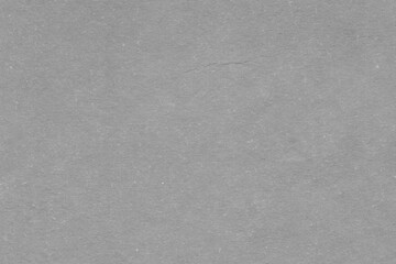 Cardboard gray texture close-up. Light old paper background. Grunge concrete wall. Vintage blank wallpaper.