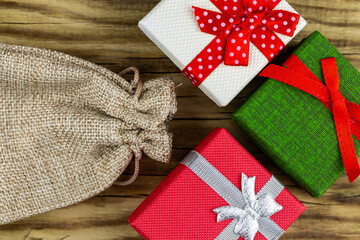 Colorful gift boxes stacked on a wooden background
