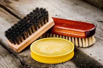 Accessories for the care and cleaning of shoes on a wooden table
