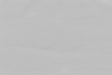 Cardboard gray texture close-up. Light old paper background. Grunge concrete wall. Vintage blank wallpaper.