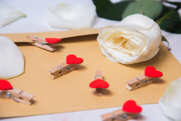 rose with hearts on a paper envelope as a background. valentine's day celebration and eighth march concept


