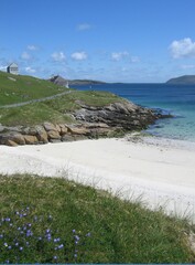 Sandy beach and rocky promontory on the island of Vatersay, Outer Hebrides, Scotland on a sunny...